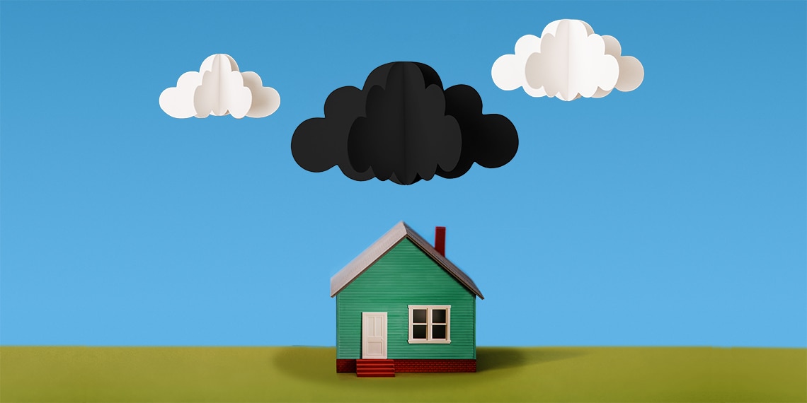 An image of a house with a dark cloud overhead.