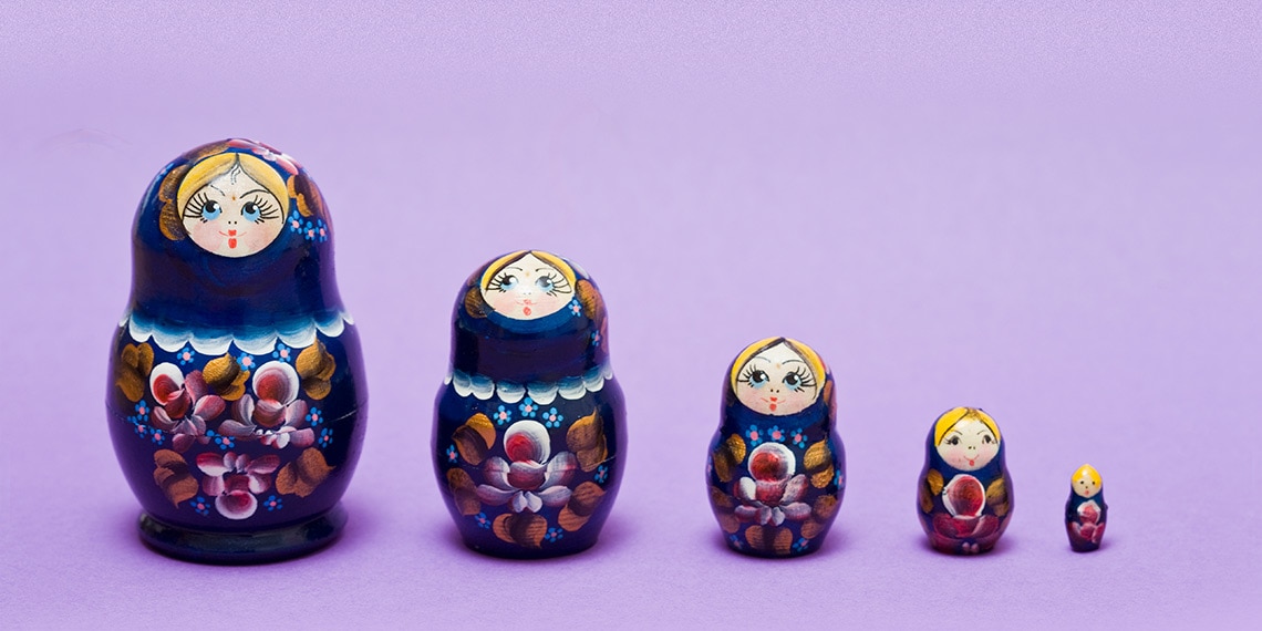 A set of nesting dolls lined in a row.