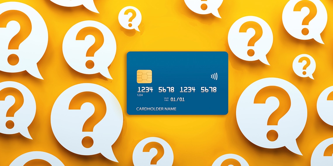 Credit card surrounded by a series of question marks.