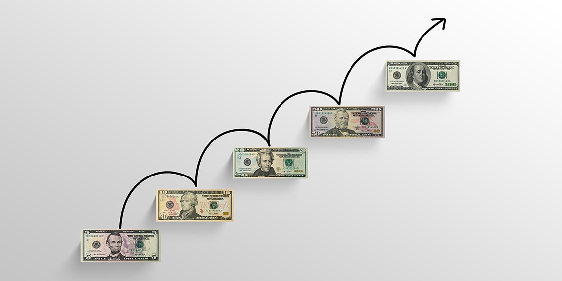 Escalating dollar bills of different denominations.